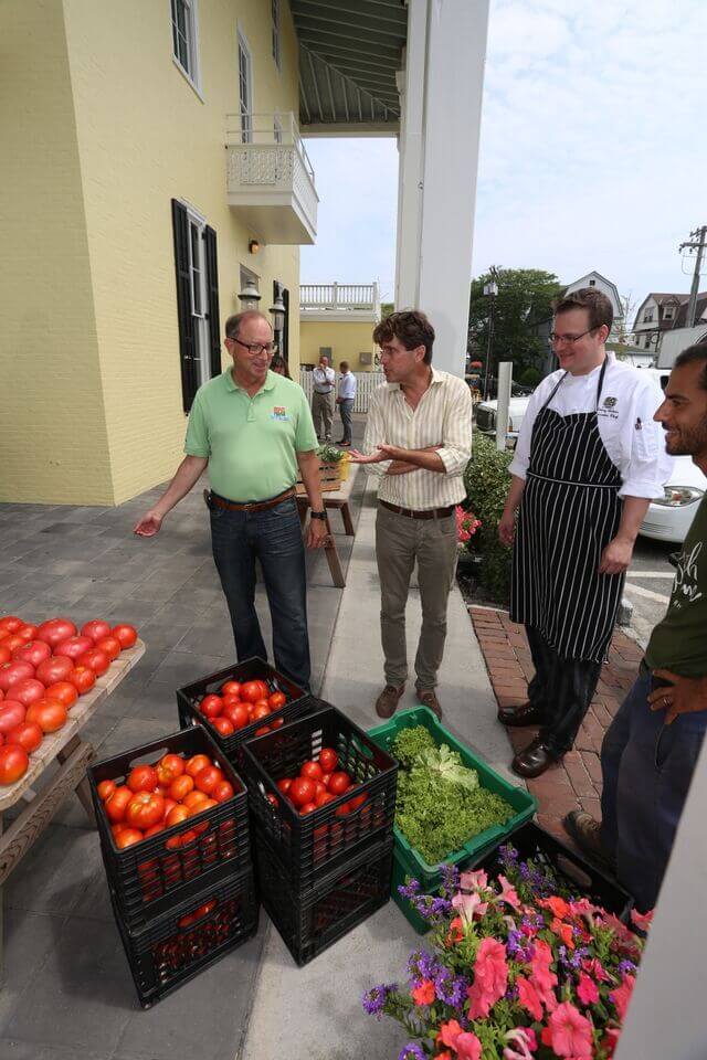 Secretary Douglas Fisher checks out the daily delivery of fresh produce to Blue Pig Tavern that was just picked from Beach Plum Farm