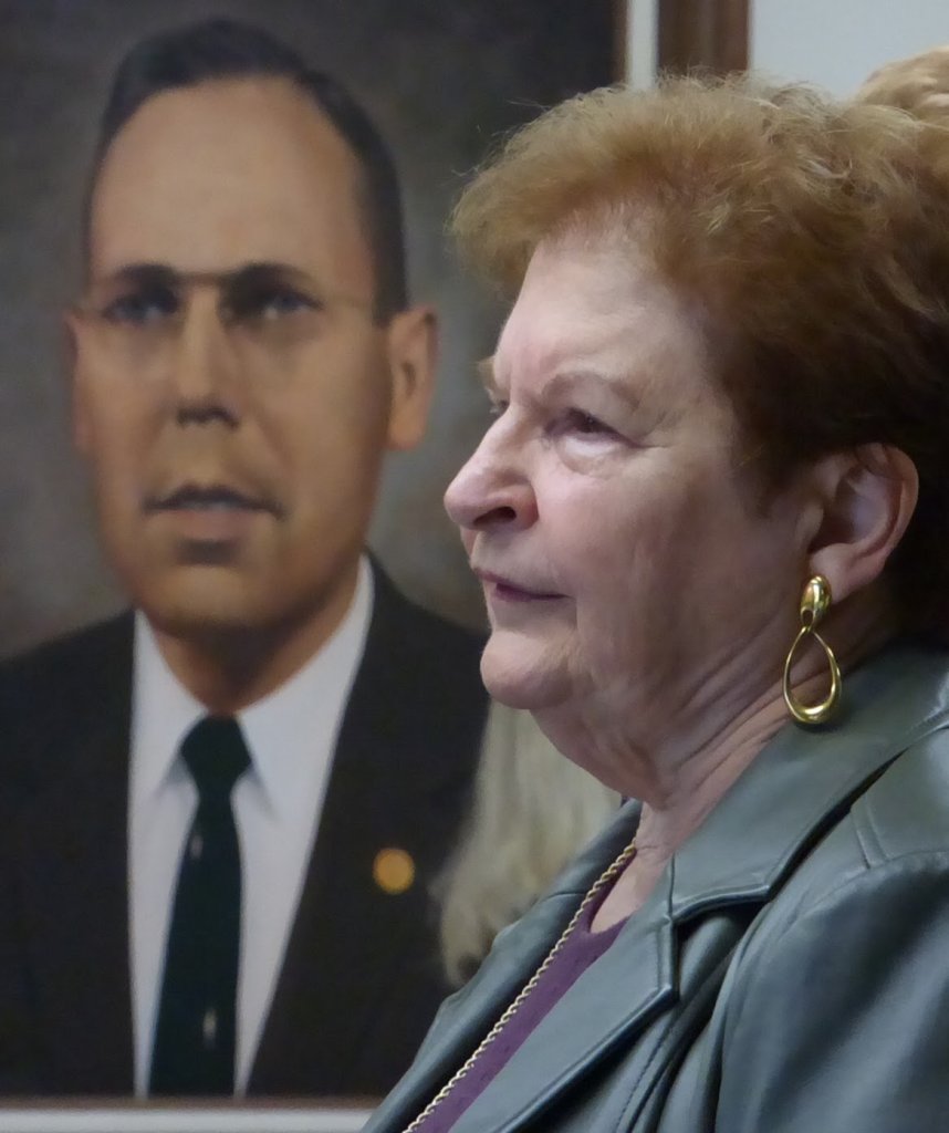 Judith Hansen with portrait of Dr. Lyle Hagmann