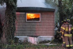 Flames consume the mobile home of John Kennedy Oct. 21 at Presidential Trailer Park