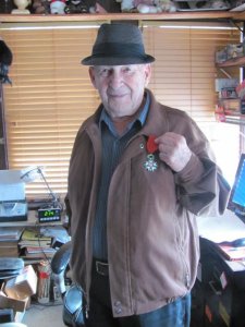 Henri Bedard holding his medal.