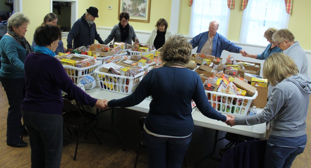 Parkway South Church members and Thanksgiving basket volunteers gather for prayer and blessings as they work to ensure everyone has a reason to be thankful on Thanksgiving Day.  