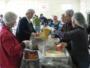 People of all ages joined together to package meals to feed the hungry of the world. Some filled ingredients of rice