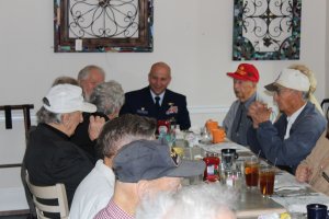 Coast Guard Training Center Cape May Commanding Officer Capt. Todd Prestidge speaks with veterans.