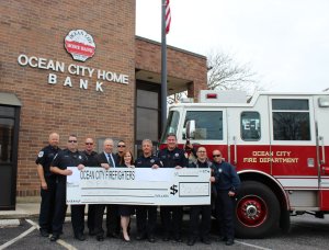 Members of the Ocean City Firefighters Foundation present Steve Brady and Tricia Ciliberto of Ocean City Home Bank with a check for $12