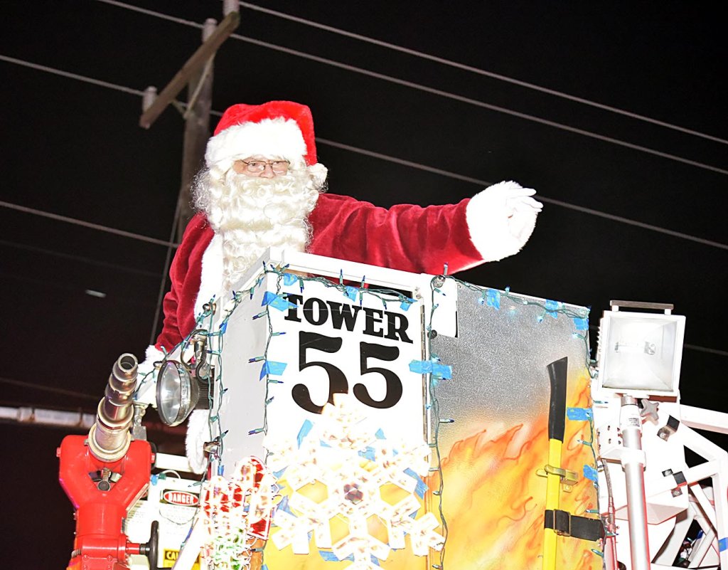 Santa Claus waves hello to the children.