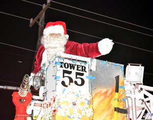 Santa Claus waves hello to the children.