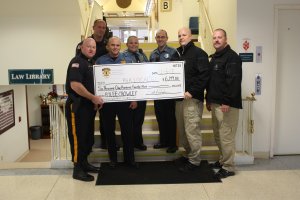 Officers make a donation to the Rylee Crowley Fund. L to R: Corrections Sgt. Steve Prince