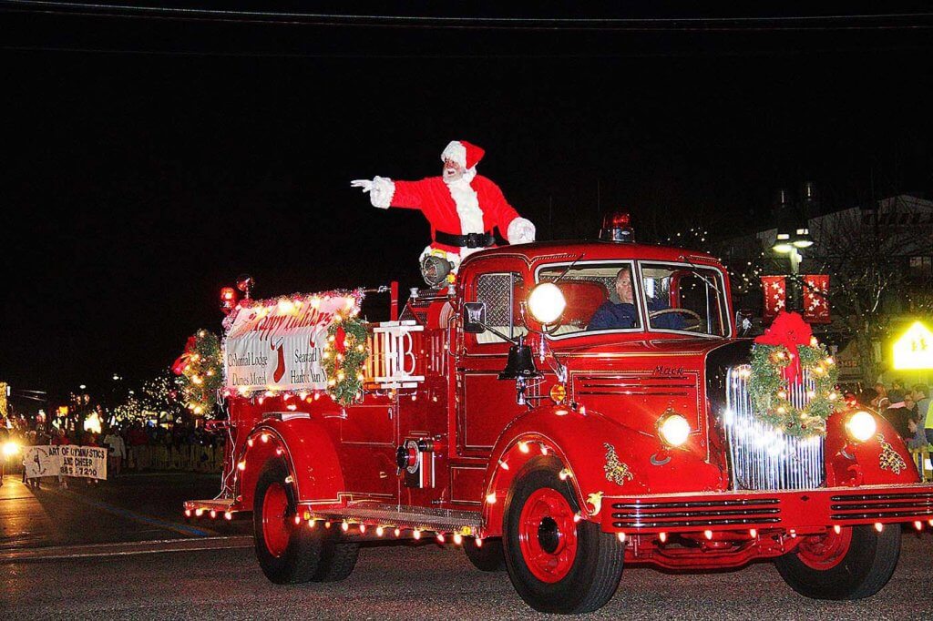 Santa Claus waves to the crowd.