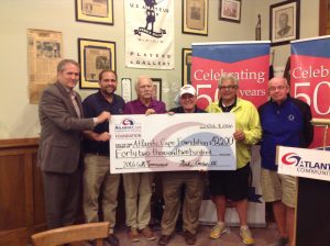 Pictured with a check of the funds raised is Charles Pessagno