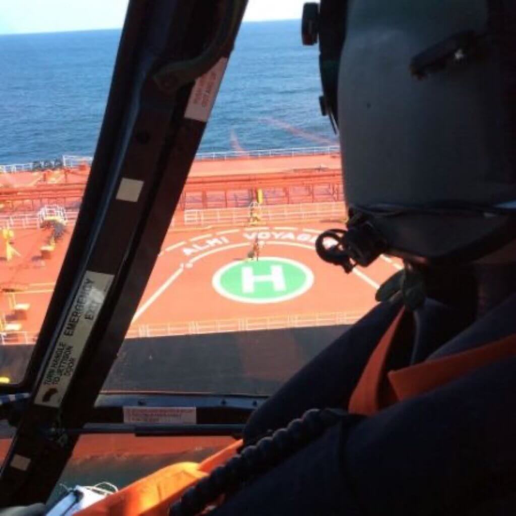 A U.S. Coast Guard Air Station Atlantic City pilot looks out over the Almi Voyager during a medevac March 6. The helicopter crew transferred the captain of the Almi Voyager after he suffered a leg injury to Atlantic City Trauma Center