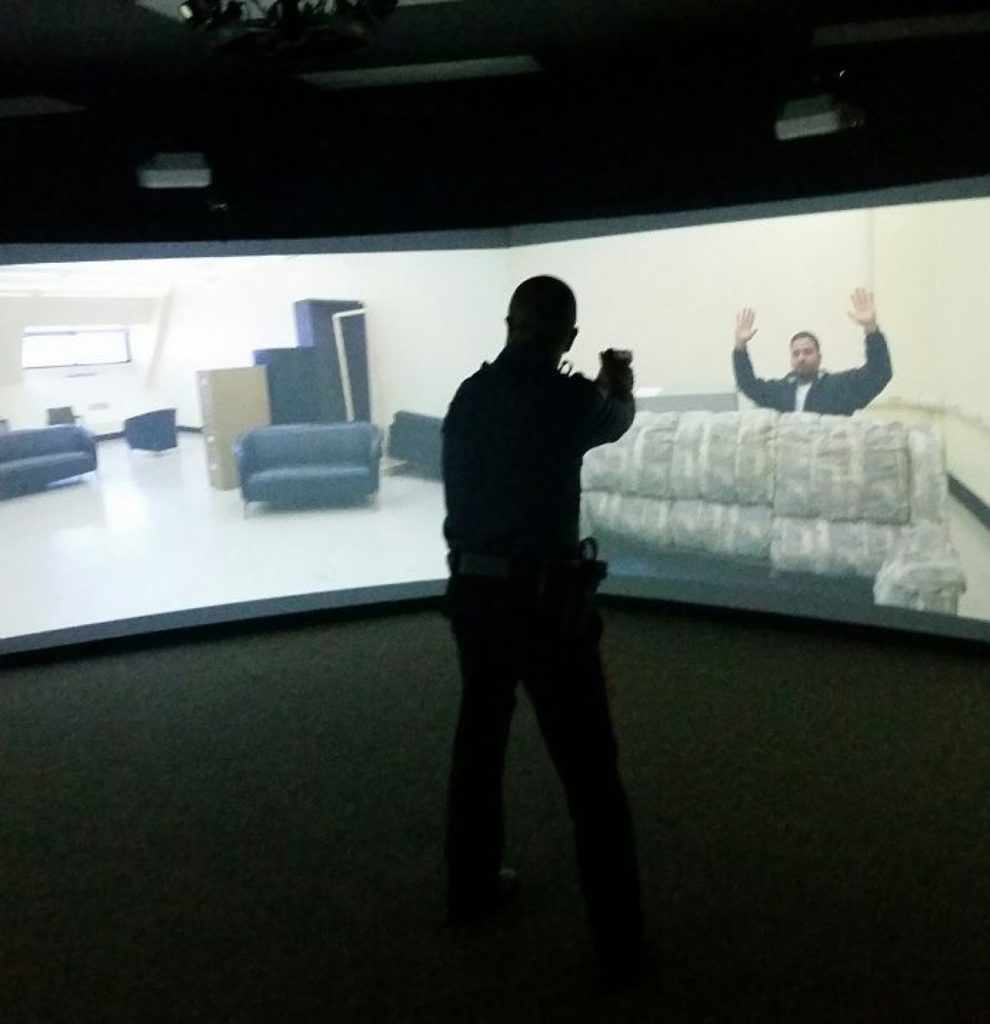 Police officer uses recently purchased simulator at Cape May County Police Academy to train reactions to stressful situations.