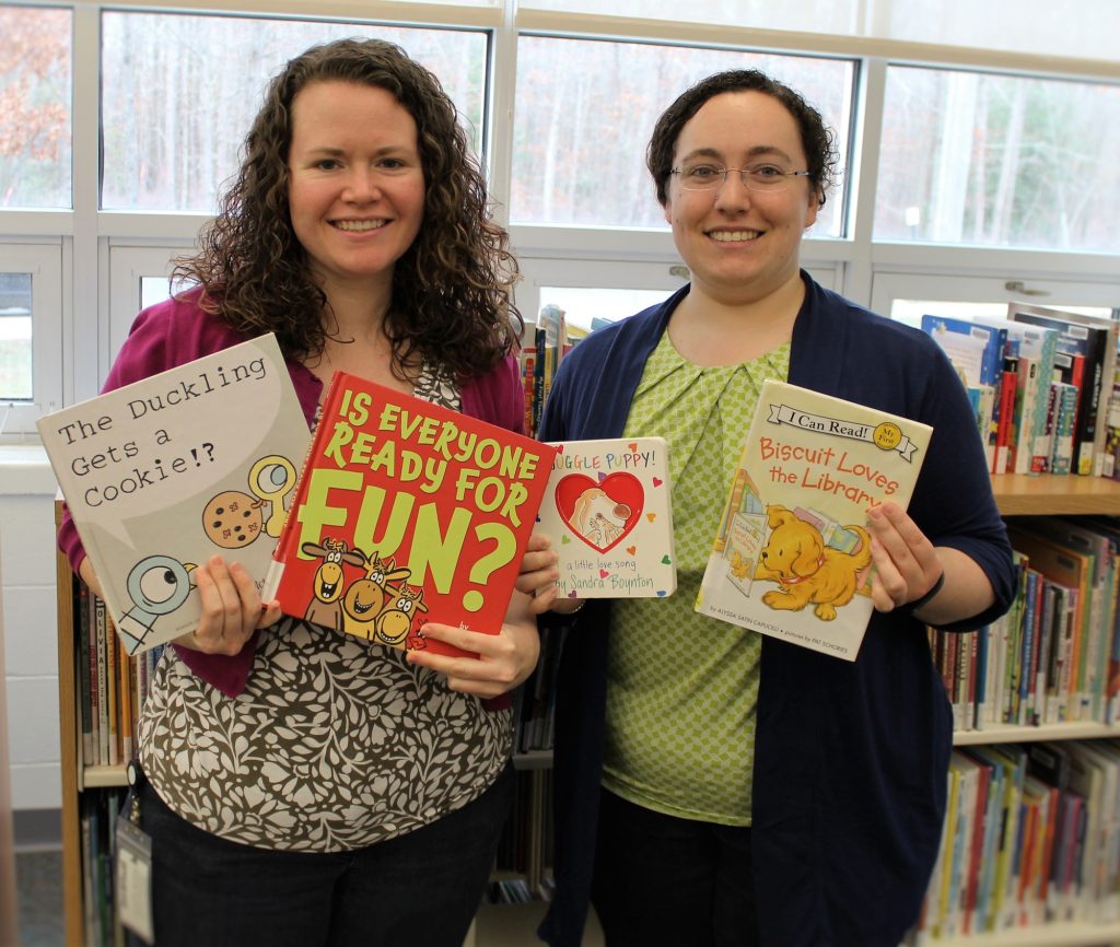 Children's Librarians Kellie Large and Alice Mitchell show off some of their favorite books at Woodbine Branch.