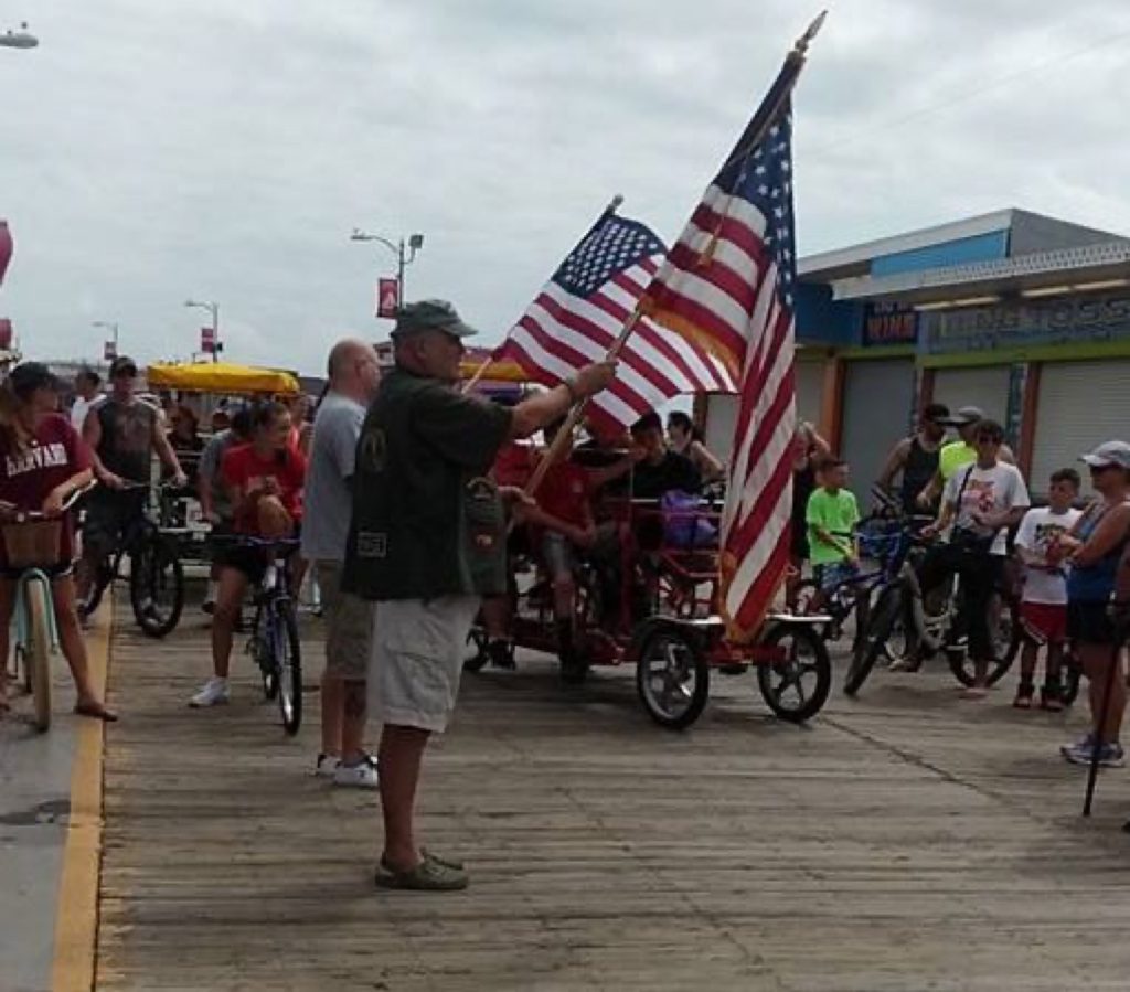 Protesters hold American flags outside a Boardwalk store Aug. 2.