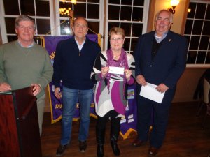 Lions Club Officers present check to Volunteers in Medicine’s Barbara Harvey