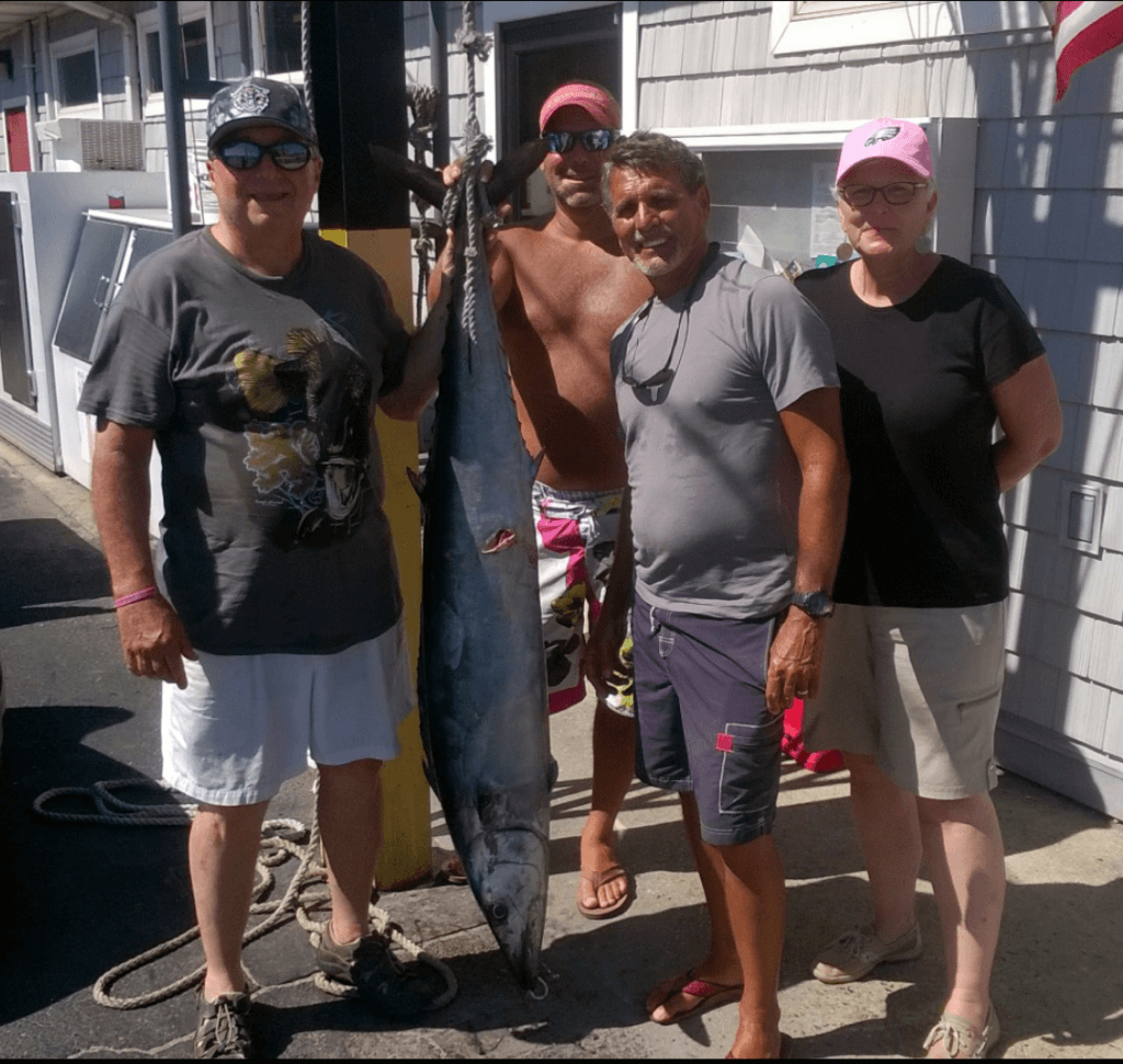 The crew from the “Three Petes” and their 60 pound wahoo. 