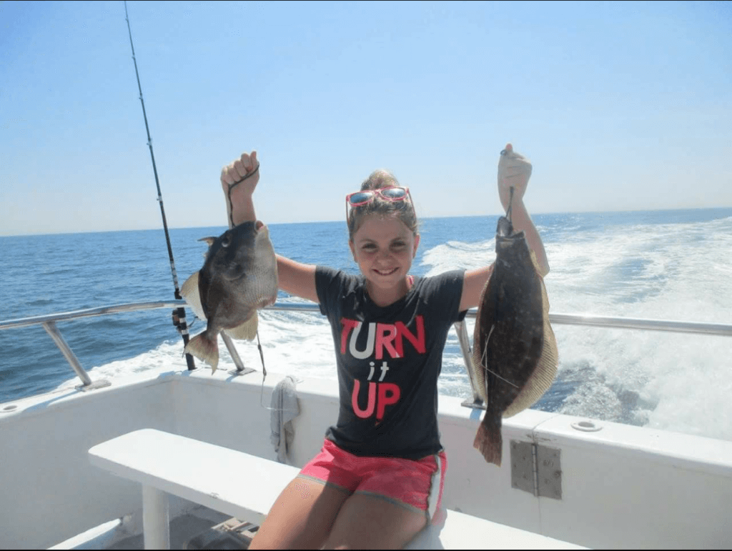 A proud young angler with her trigger fish and flounder.