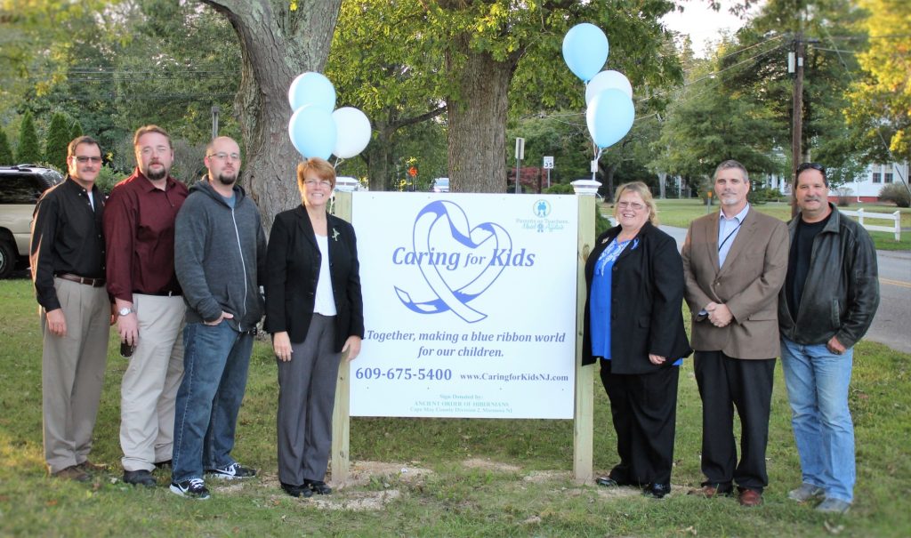 Members of the Ancient Order of Hibernians present a new sign to Caring for Kids Oct. 12 at an open house. Left to right: Mike Hagen