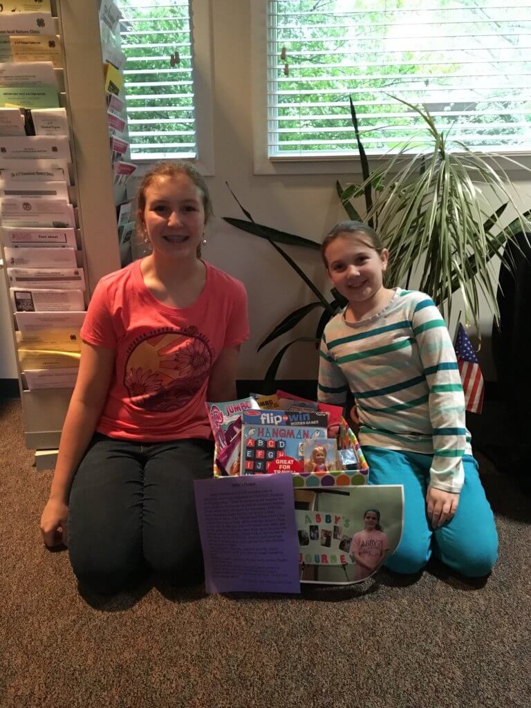 Samantha Downes and Nora Conover from the Needle and Thread 4-H Club with the donation box created to collect toys for the children at the hospital.