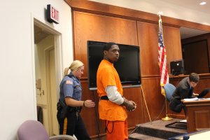 Derrick Powers is led into court Sept. 9.