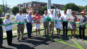 Stone Harbor Mayor Suzanne Walters is joined by borough officials and those from U-Go Stations July 15 cutting the ribbon for an electric car charging station at the borough's 94th Street parking lot.