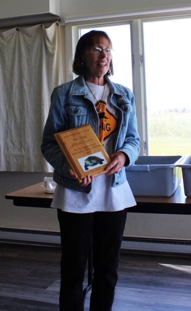 Kindergarten teacher Roberta Dean with a plaque marking 25 years of terrapin awareness.