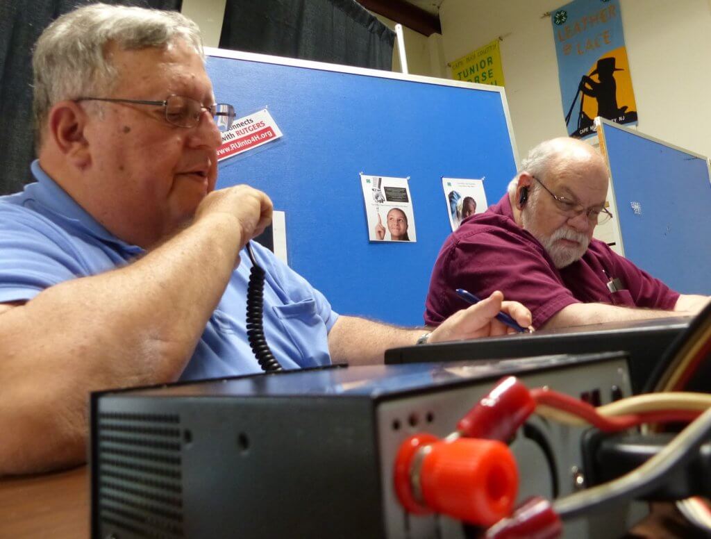 Steve Duda and Robert Myer listen for contacts after transmitting on high frequency band June 25 at 24-hour amateur radio field day in Court House. 