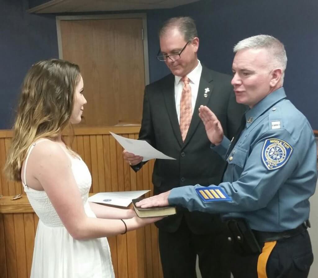 Capt. William Adams takes oath from Mayor Michael Clark.