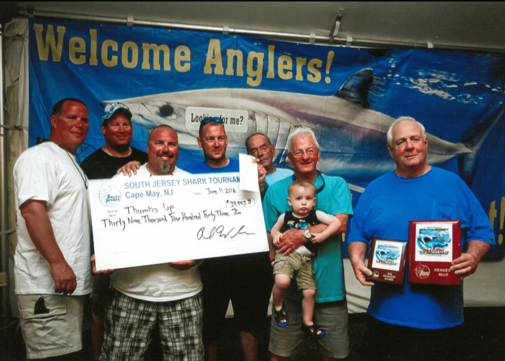 The winning crew of the “Thumb’s Up” that took first place in the Blue Shark division.