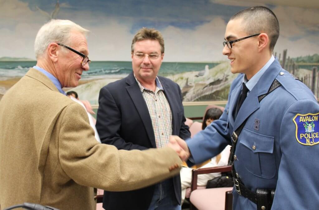 Mayor Martin Pagliughi swears in Patrolman Andrew Peahota.