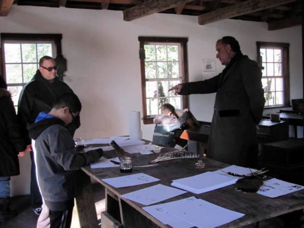 Jim Stephens explains schoolhouse features to visitors Dec. 3 at Historic Cold Spring Village.