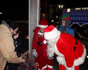 Santa and Mrs. Claus exit their float