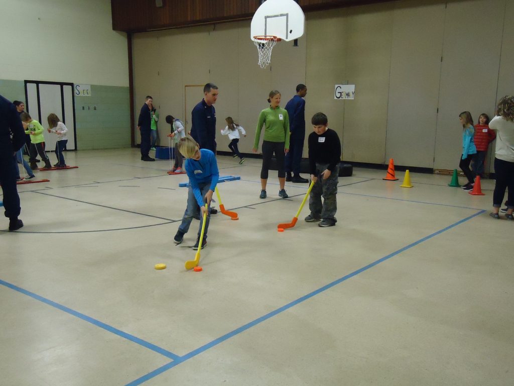 Luke Hutchinson and Zander Hardy Compete against Coast Guard recruits to score a goal in Hockey.