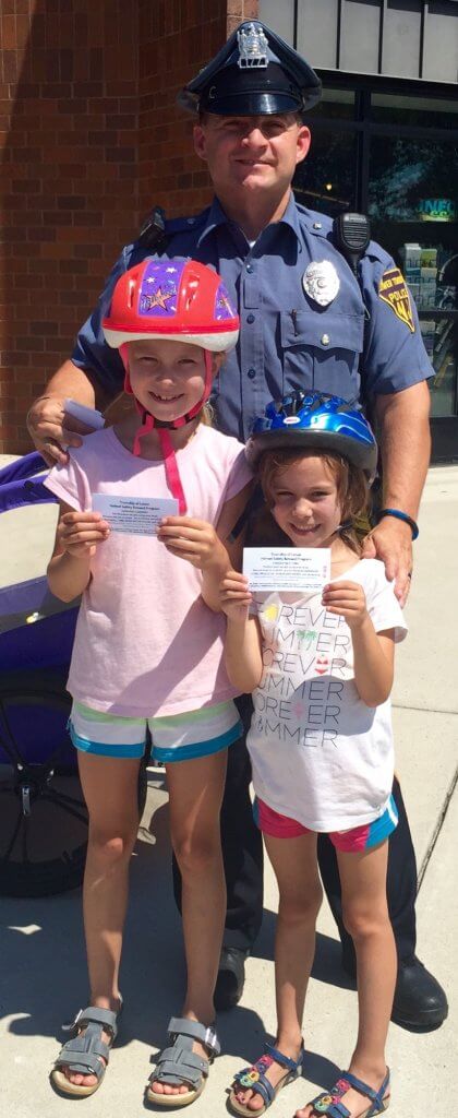 Stella and Sienna Rekow with with Officer Eric Coombs.  