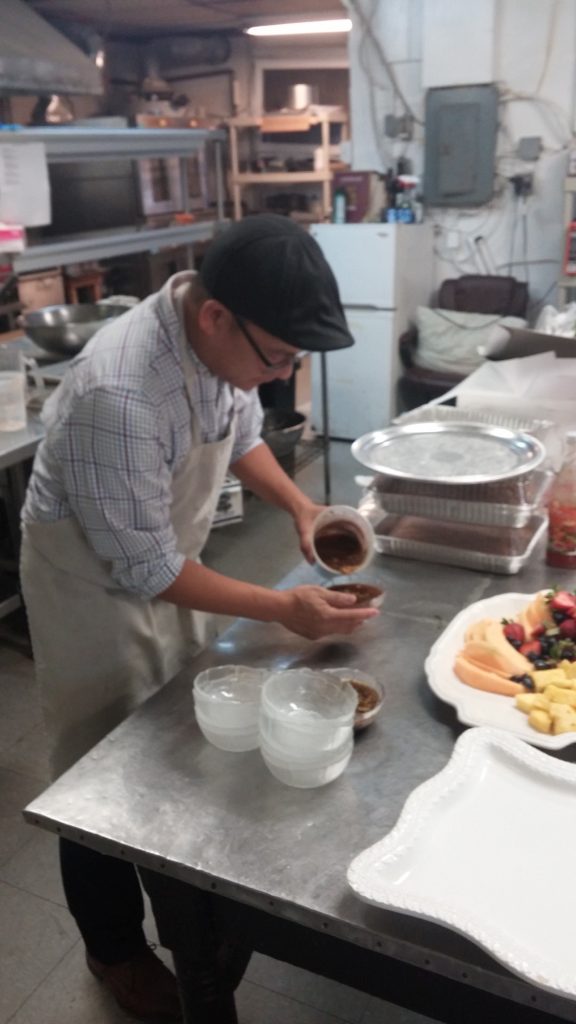 Canh Ho prepares the ginger sauce for Vietnamese food at a benefit Oct. 23.