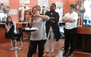 Cindy Pleasants of Headlines Professional Hair Care demonstrates an asymmetrical bob haircut to students of Cape May County Technical High School’s continuing education hairstyling course.