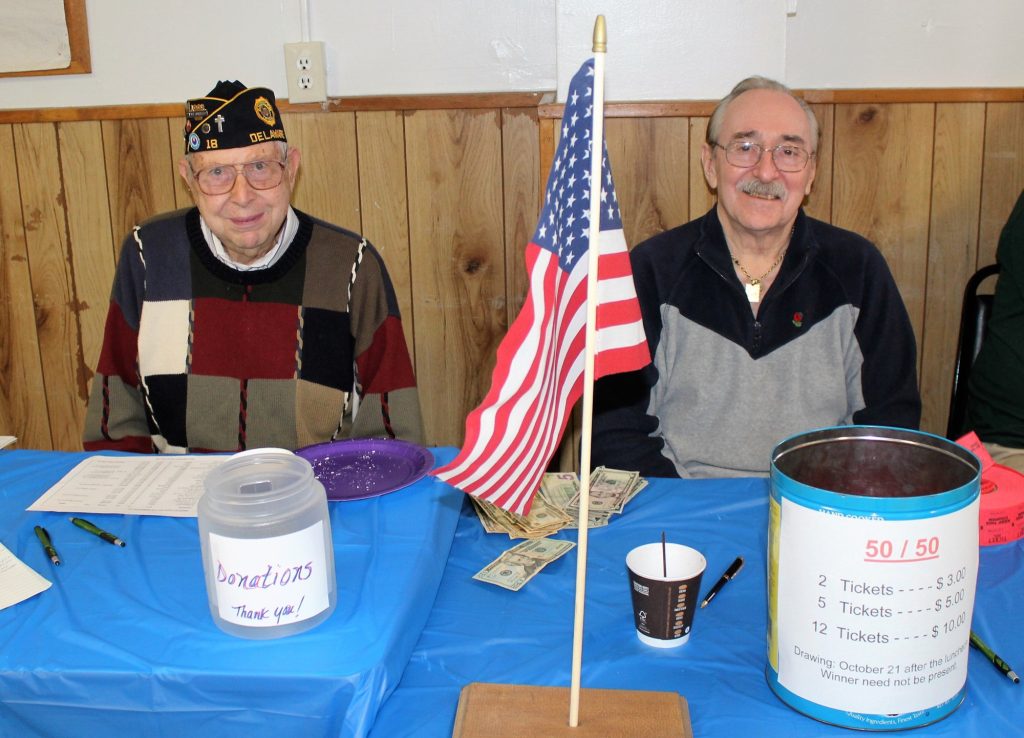 Charlie Helwig and Michael Vallone volunteer at the donation and 50/50 raffle at the Veterans Appreciation Meet-and-Greet Breakfast