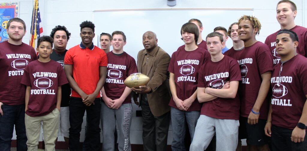 Wildwood High School football players are all smiles with Super Bowl hero Randy Beverly.