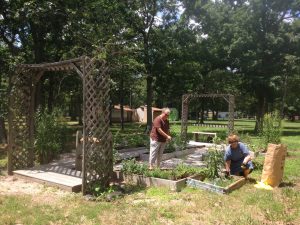 Master Gardeners Brenda Church and Barbara Douglass put final touches on the Irma McVey Memorial Herb Garden for the 4-H Fair.