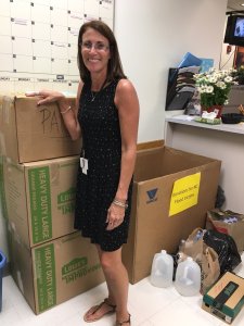 Middle Township High School Supervisor-teacher Rita Willis with some of the 19 boxes of goods collected by students for the relief of flood victims in Grifton