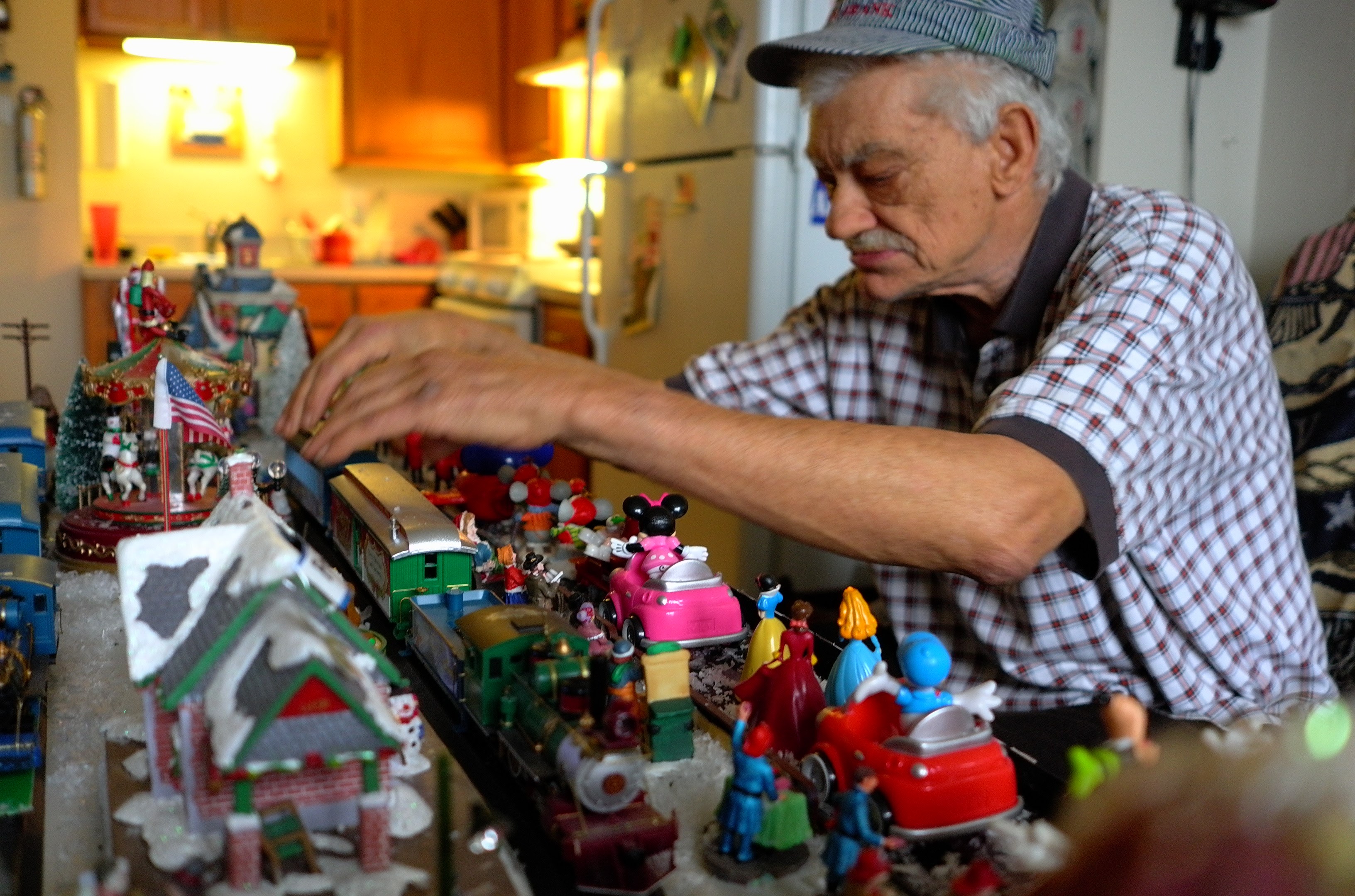 Francis "Frank" Dachowski works on HO-scale trains and village in his North Cape May apartment.