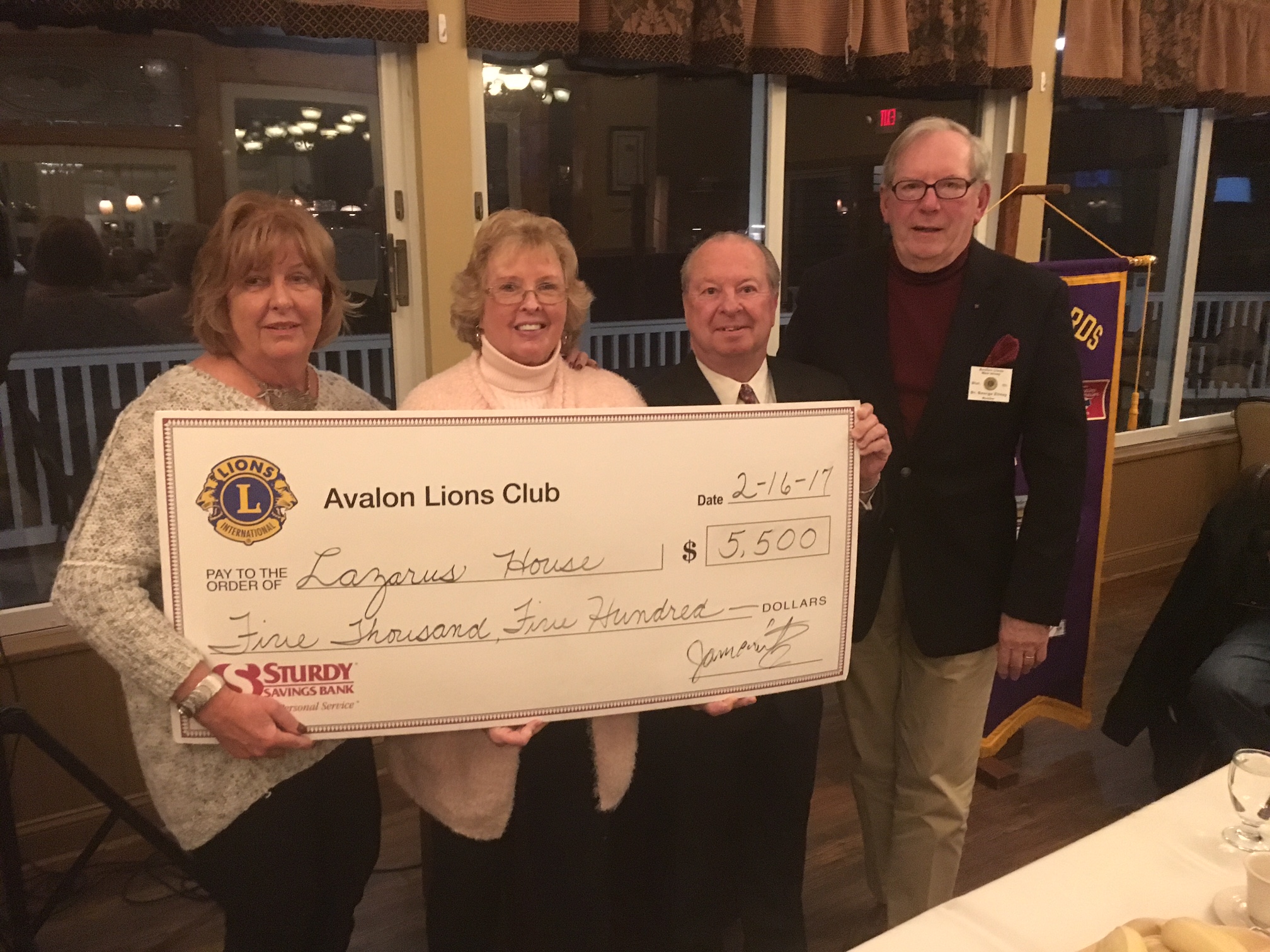 L to R: Avalon Lions members Pat Williams and Eileen Donovan present a check to Lazarus House director