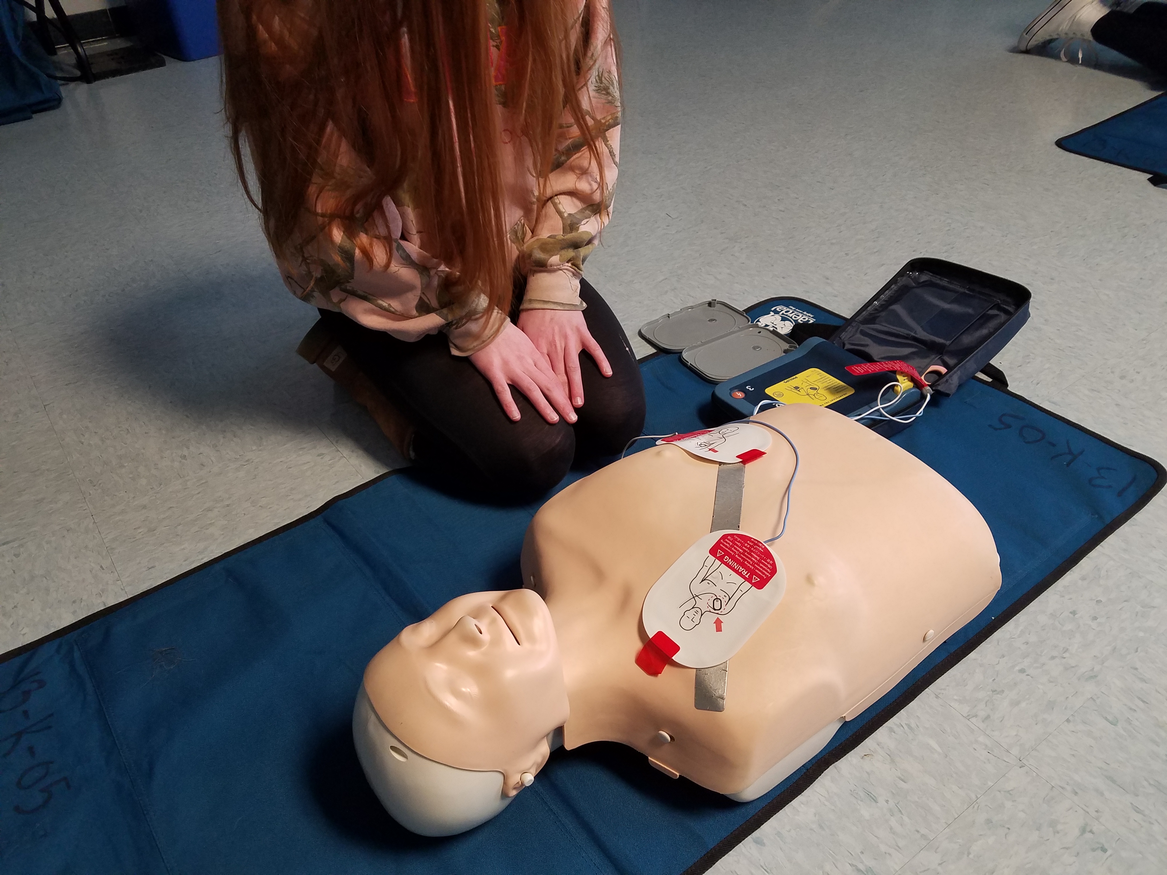 An Ocean City High School student sets up the AED. 