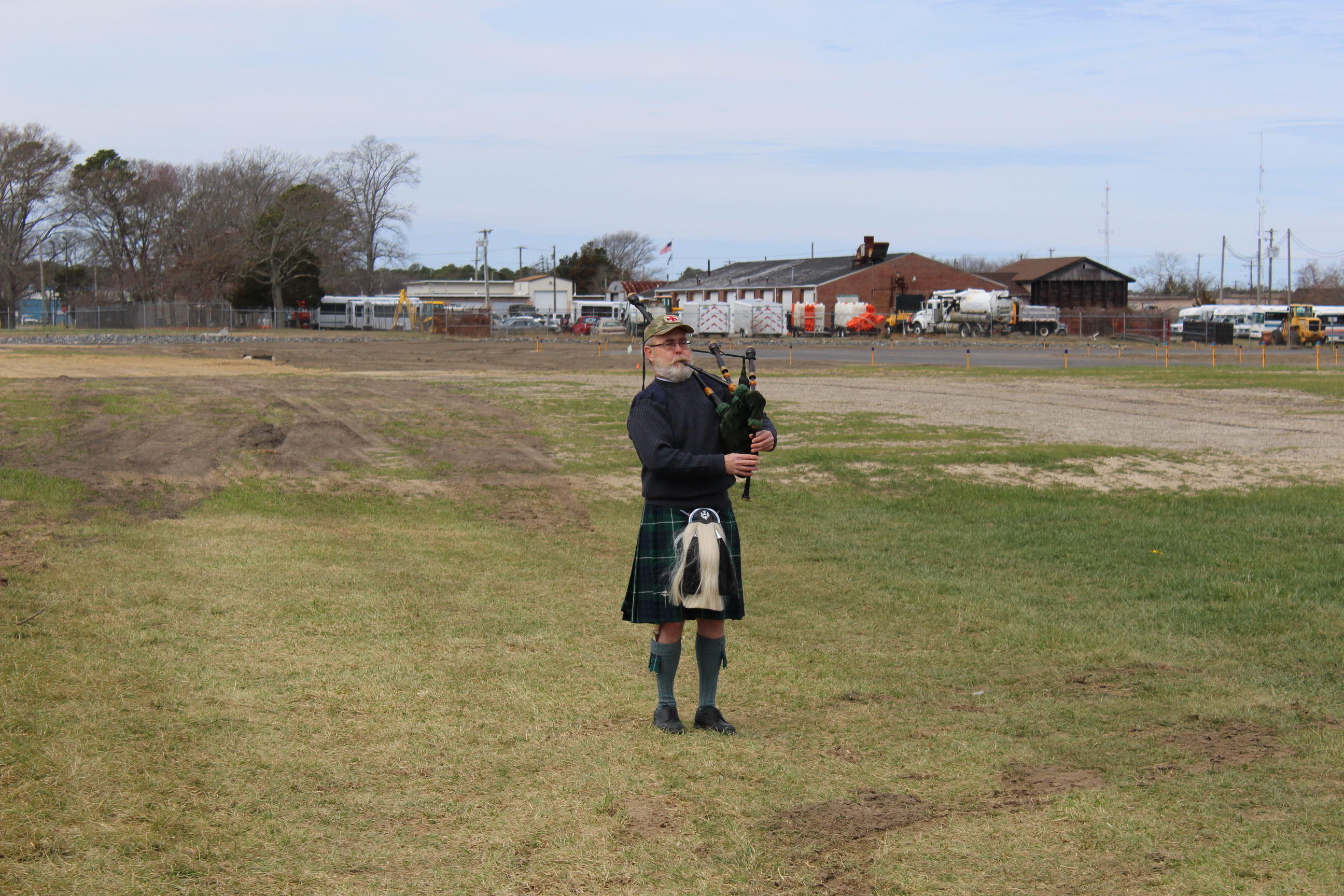 Doug Hamilton plays "Amazing Grace" March 30 at Cape May County Airport as family members of Ensign Andrew Hamilton place wreath at the location where the 23-year-old naval aviator was killed while training during World War II.