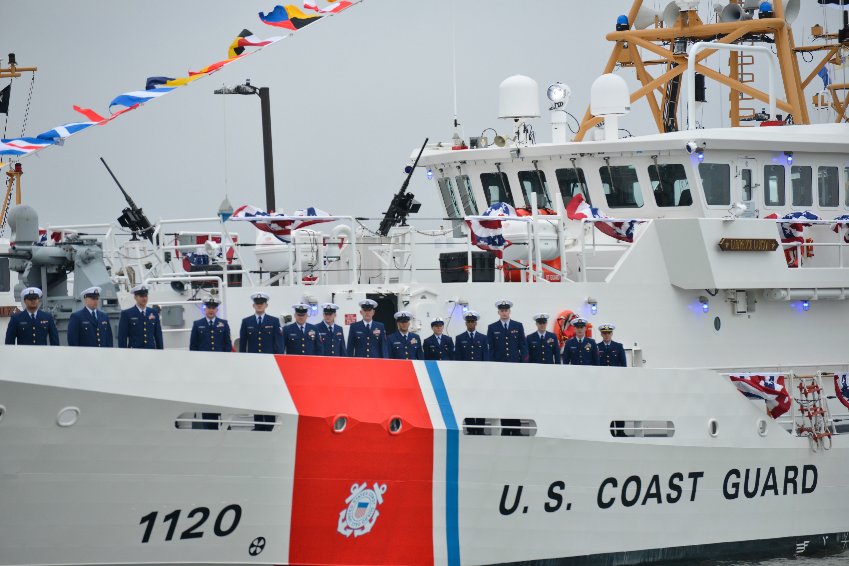 The crew of Fast Response Cutter Lawrence Lawson gathers on the newly commissioned cutter during a commissioning ceremony held at TRACEN