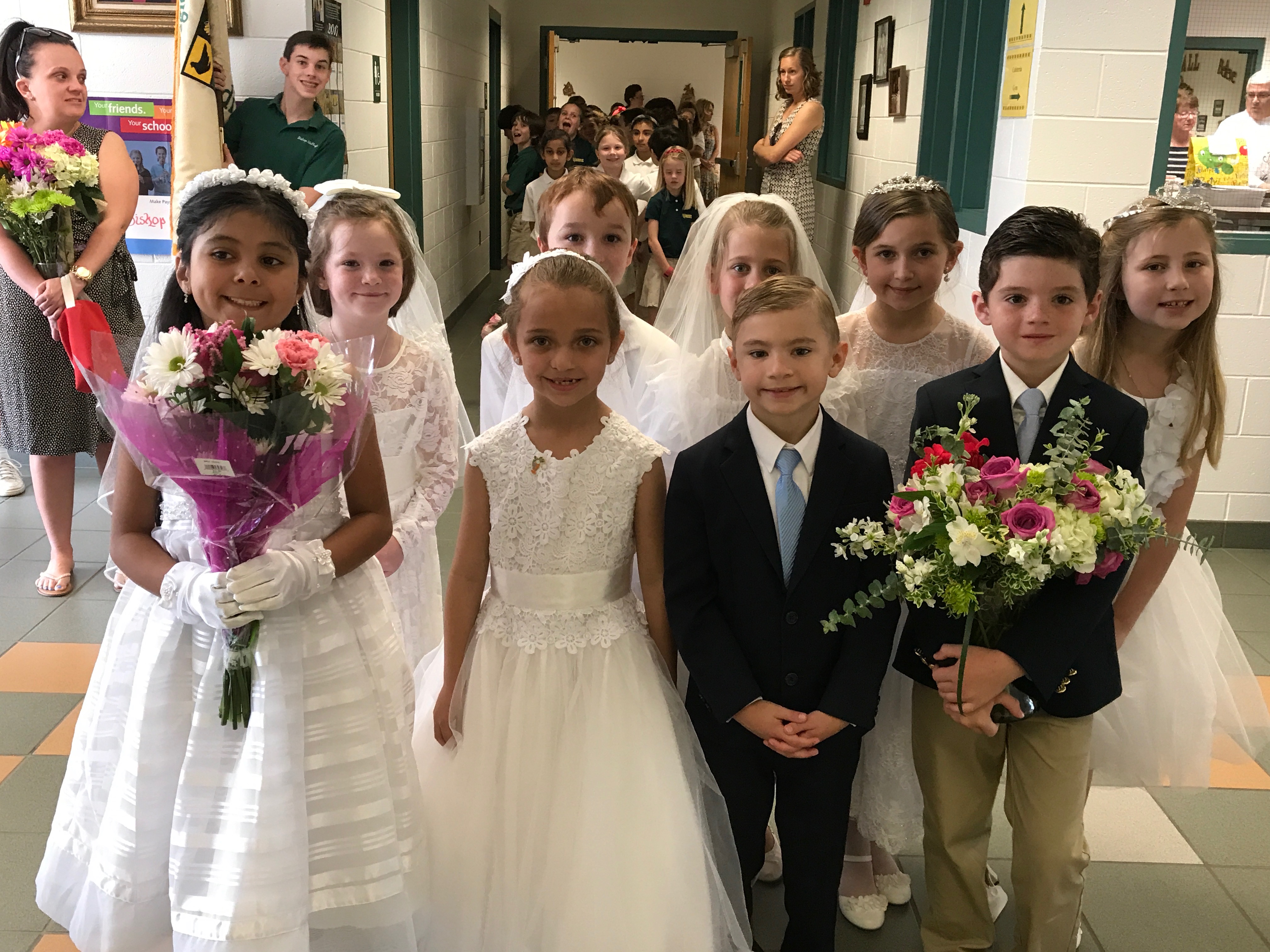 Second graders who made Holy Communion this year are ready to lead the student body in the May Procession. Left to right (front) are Zeleste Martinez Panesso