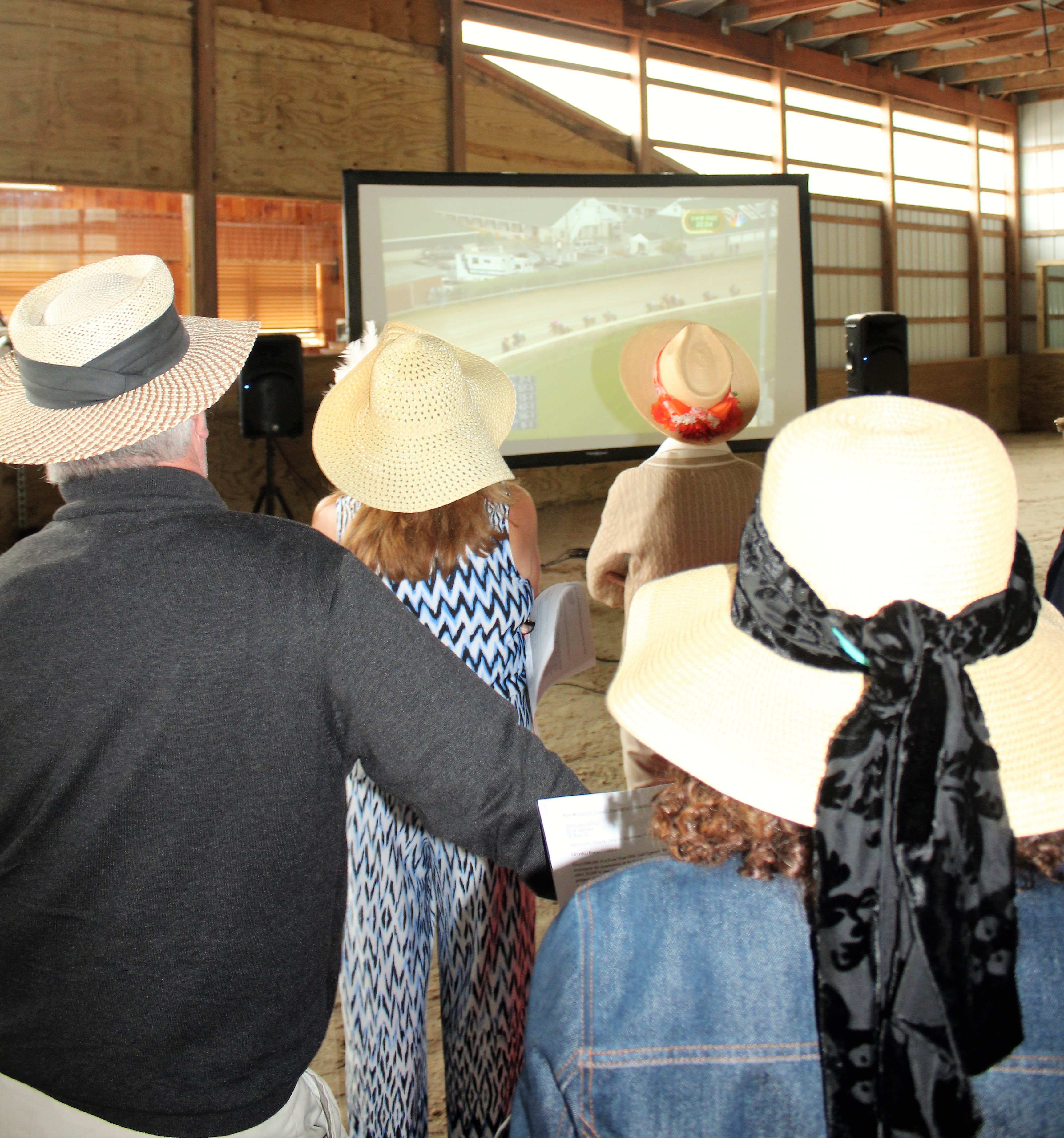 Derby fans watch the horses round the track enjoying the day and raising money at The Branches Kentucky Derby fundraising party May 6.