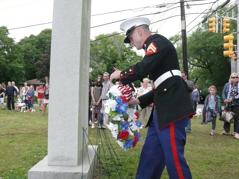 Middle Township Memorial Day parade grand marshal Lance Cpl. Nick Anzelone places a wreath at the veterans monument during township ceremony May 29. 