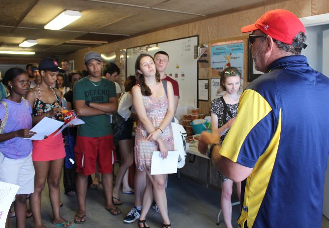 Beach Patrol Capt. Ed Schneider warns international students about the dangers of swimming without lifeguards on duty.