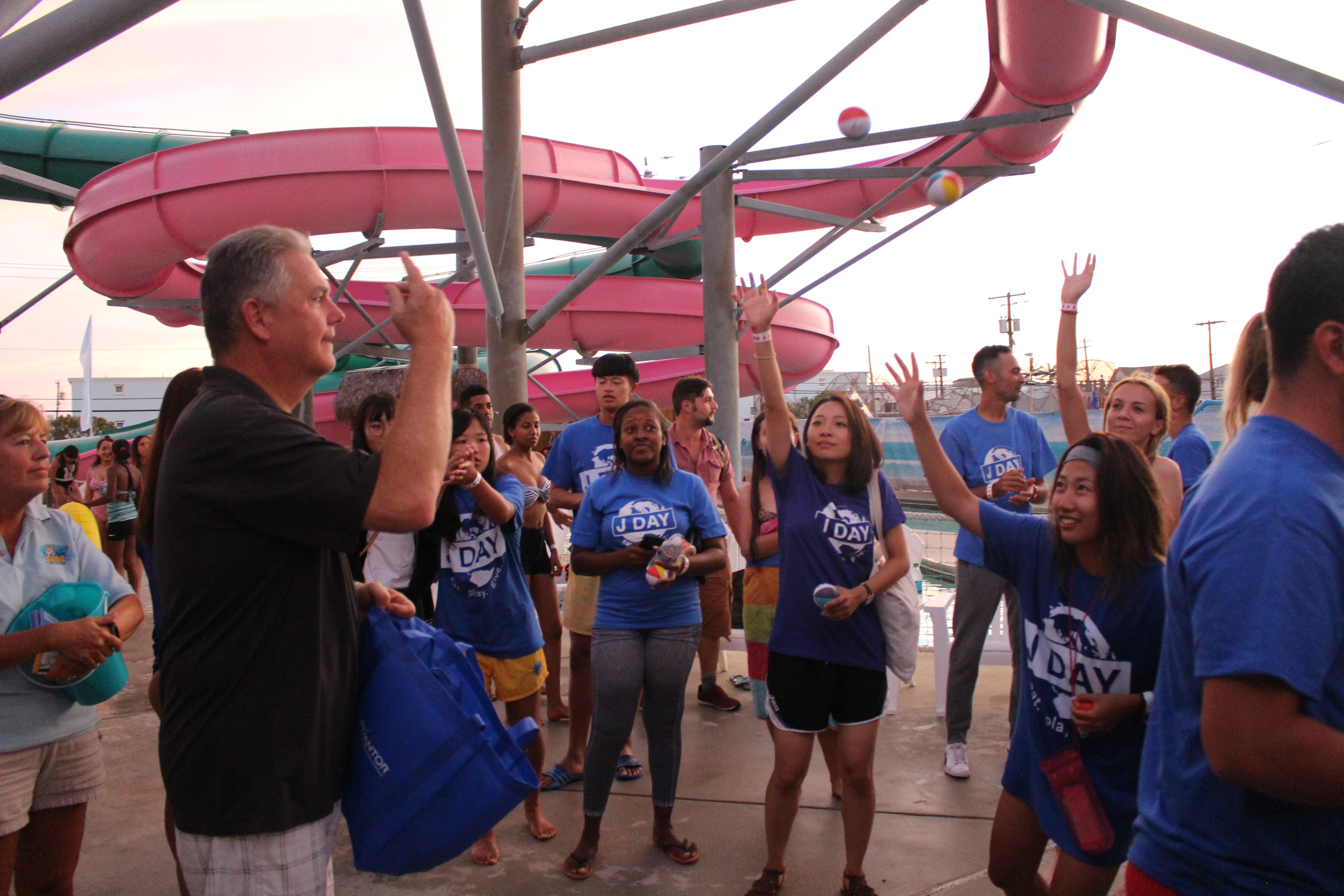 John Lynch throws beach balls that students who catch them can trade for prizes during J-Day at Splash Zone Waterpark.