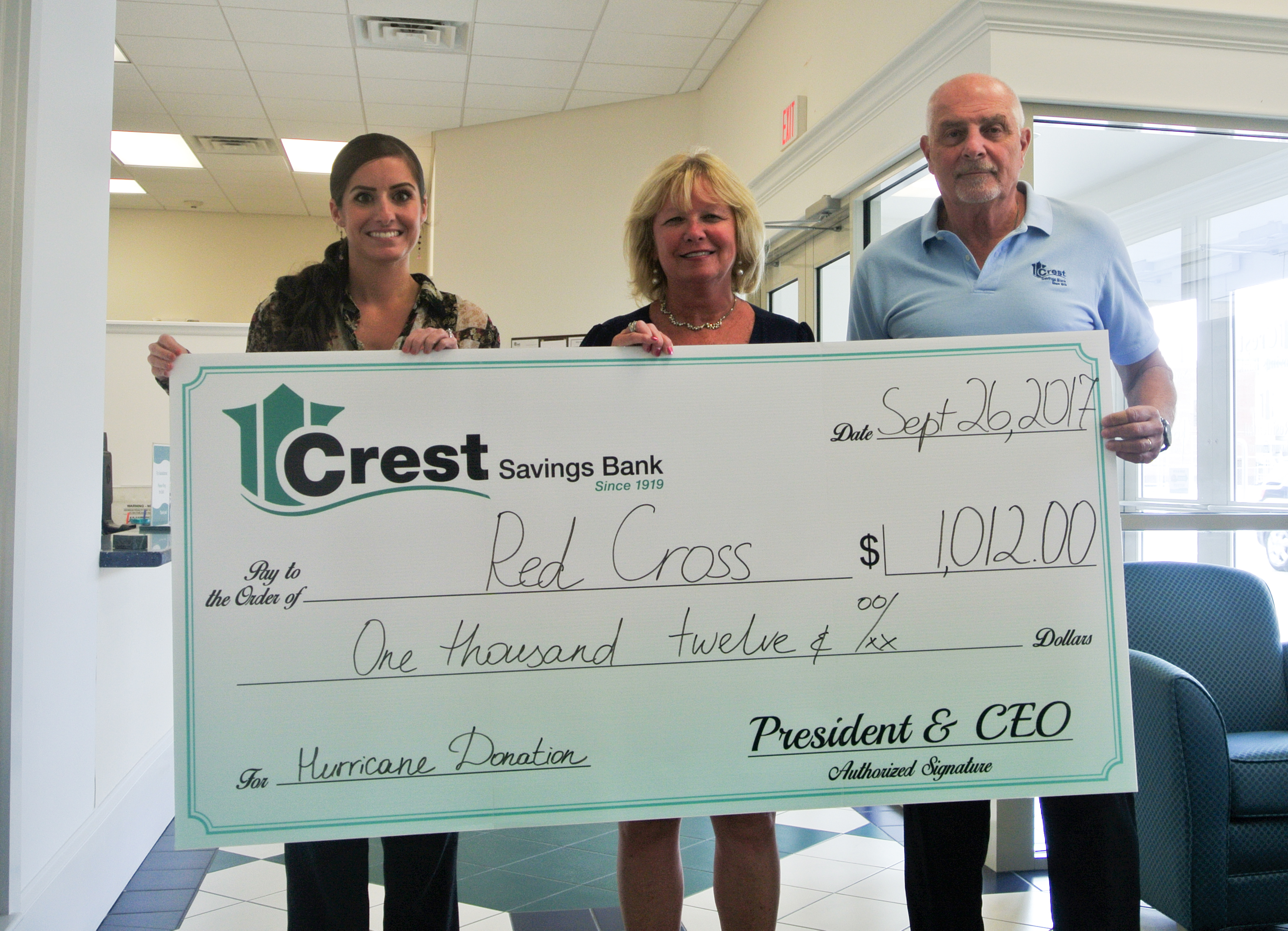 Maggie Colwell (far left) and Frank Lupo (far right) are seen here presenting a check to Ronnie Town